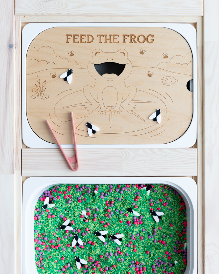Feed the Frog laser engraved wood sensory tray with bug loose parts and pink tweezers, fitting an IKEA Trofast bin.