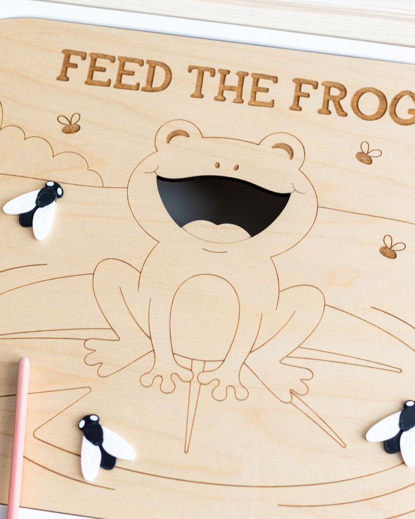 Feed the Frog laser engraved wood sensory tray with bug loose parts and pink tweezers, fitting an IKEA Trofast bin.